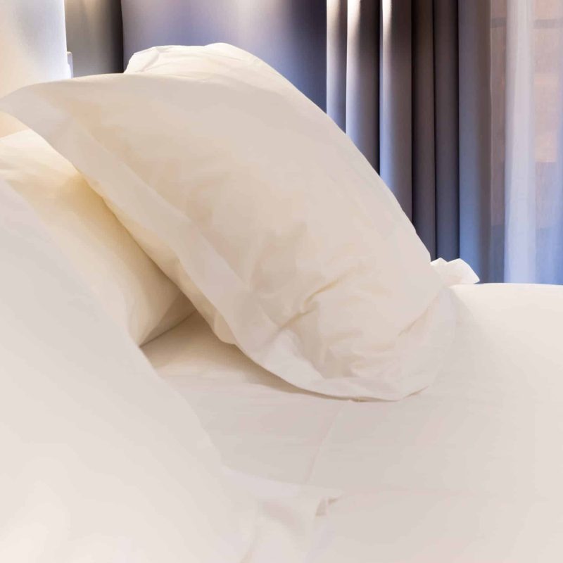 Night scene in hotel room: prepared fresh bed